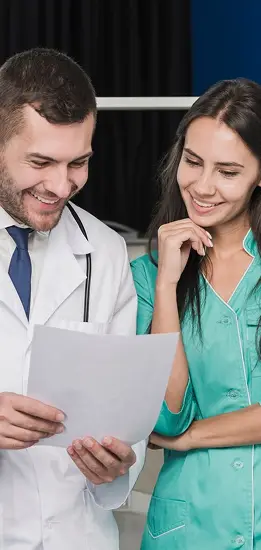 Doctor reviewing medical documents with a patient during a consultation in a professional healthcare clinic.